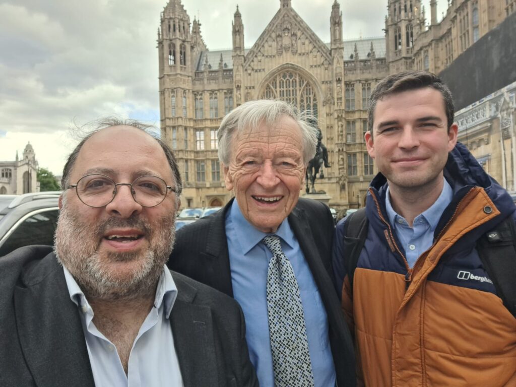 Selfie in front of the Houses of Parliament. Stood left to right are: David Mason, Lord Alf Dubs, and Jack Kushner