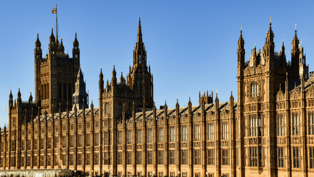 A view of the UK Houses of Parliament on a sunny day.